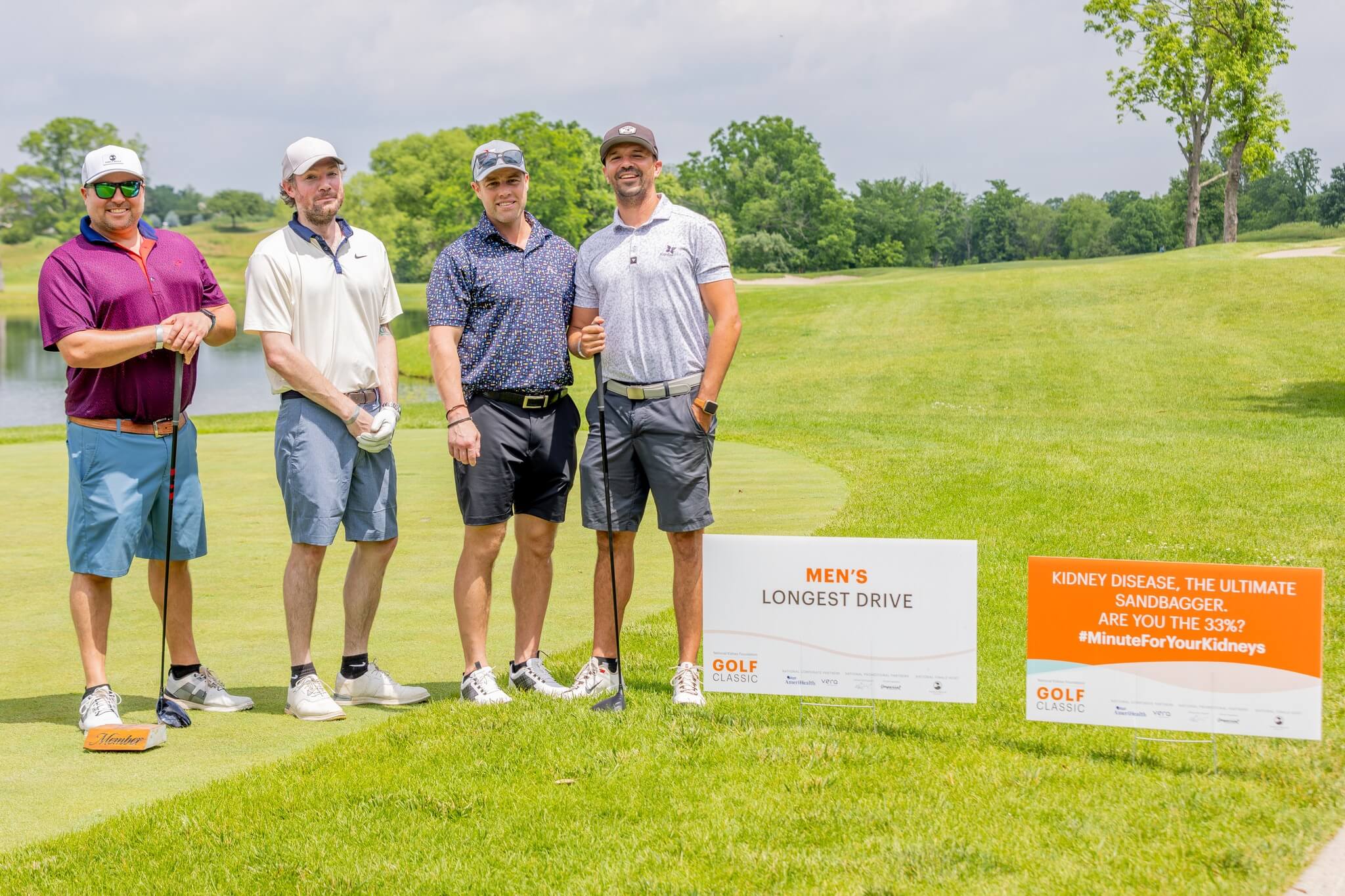 Foursome at the Men's Longest Drive marker